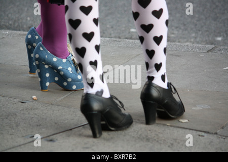 Cropped view of women standing on street wearing fashionable tights and rockabilly shoes Stock Photo