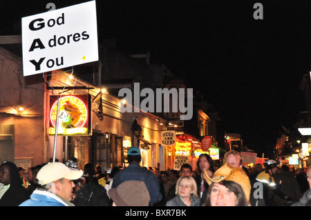 Religious activist with 'God Adores You' sign on Bourbon Street, French Quarter, New Orleans, Louisiana Stock Photo