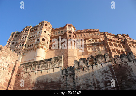 Mehrangarh Fort stands a hundred feet in splendour on a perpendicular cliff, four hundred feet above the sky line of Jodhpur. Stock Photo