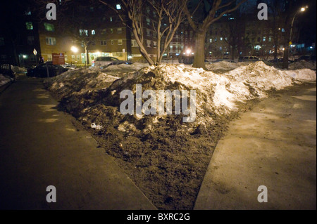 Dirty soiled snow remains in the Chelsea neighborhood of New York a week after a post-Christmas blizzard Stock Photo