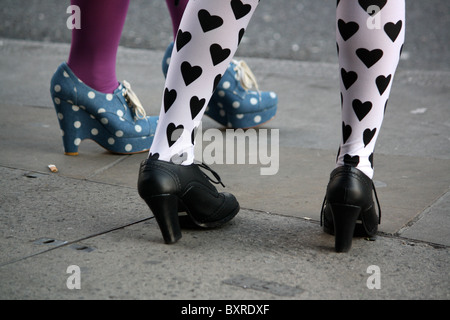 Cropped view of women standing on street wearing fashionable tights and rockabilly shoes Stock Photo