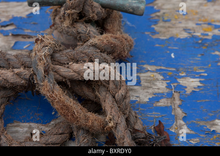 Worn rope on a worn wooden surface (boat hull) Stock Photo