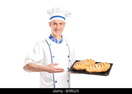 Smiling baker showing freshly baked breads Stock Photo