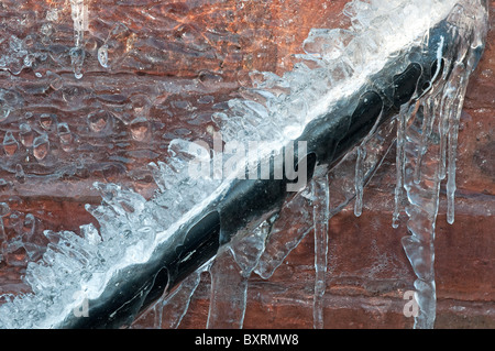 Frozen waste pipe, caused by a burst outside tap. Stock Photo