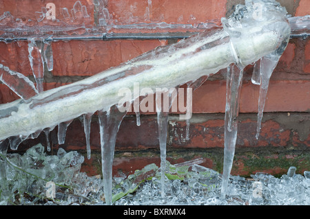 Frozen waste pipe, caused by a burst outside tap. Stock Photo