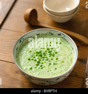 Chilled lettuce soup in a bowl with peas on top Stock Photo