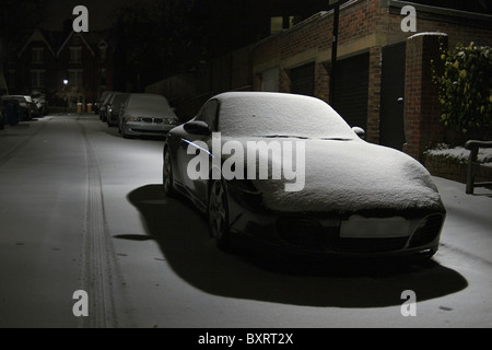 Winter snow as a blanket on a Porsche Carrera 911 in London England UK Stock Photo