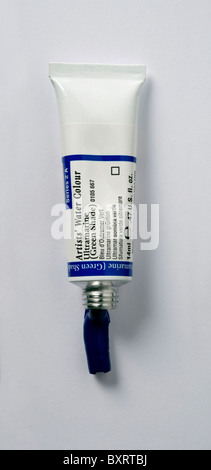 Tube of watercolour paint spilling on white background Stock Photo