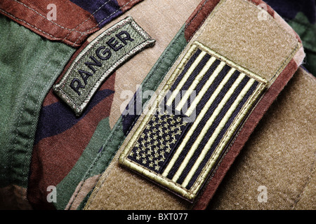 Army BDU (woodland camo uniform) with ranger patch and US flag. Stock Photo