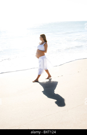 profile of pregnant woman walking Stock Photo