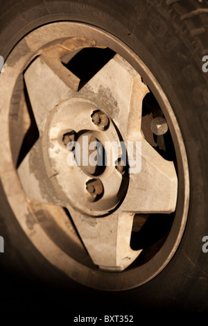 Dirty corroded aluminum car wheel Stock Photo