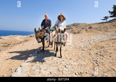 Tourists riding donkeys in Rhodes, Greece Stock Photo