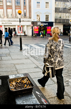 An ashtray full of cigarette butts in a street in Truro in Cornwall Stock Photo