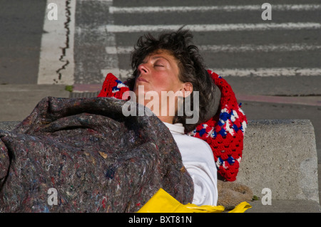 Homeless woman sleeping on city street in San Francisco CA USA California Stock Photo