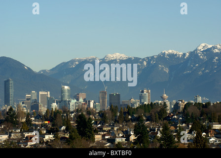 Vancouver skyline in winter with snow on the North Shore Mountains, Vancouver, Canada Stock Photo
