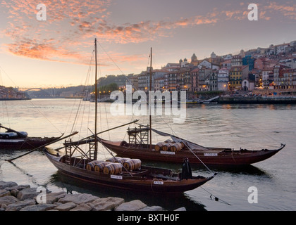 Portugal, Porto, Port Wine Barges And The Ribeira District At Dusk Stock Photo