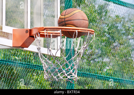 Basketball hoop on acrylic backboard and ball Stock Photo