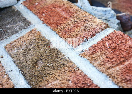 Close-up on fallen brick wall during demolition of a house. Great background with the diagonal angle and detailed texture. Stock Photo