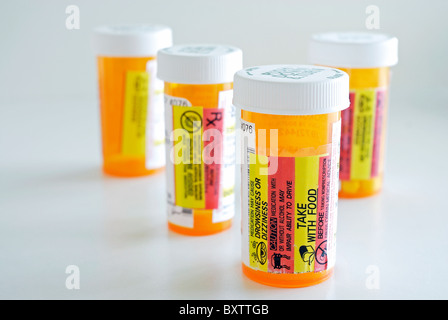 Four prescription pill bottles with focus on front bottle. Stock Photo