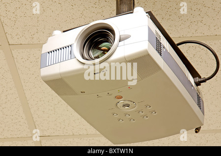 Close-up of a multi-media projector attached to the ceiling isolated on ...