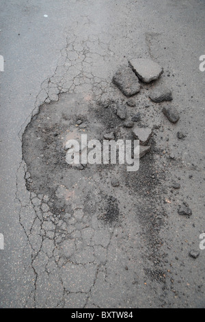 A new pot hole, the result of the heavy snow and frost in London, November & December 2010. Stock Photo