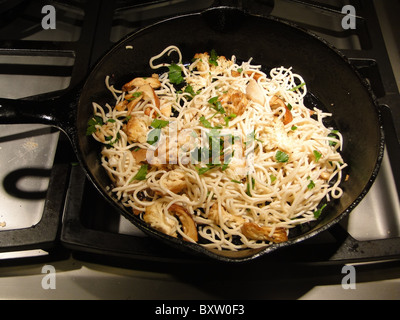 ramen noodles asian parsley wild mushroom fry saute stirfry cook castiron pan skilletfood fresh cooking raw Stock Photo