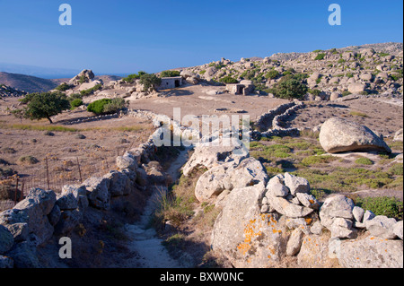 Old farm with abandoned stone buildings and stone fence, just outside Volax, on the Greek Cyclade island of Tinos. Stock Photo