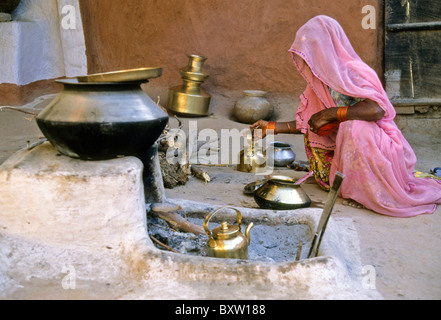 Brahmin woman in her outdoor kitchen, Rohet, Rajasthan, India Stock Photo