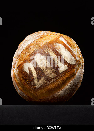 round loaf of bread dusted with the year date Stock Photo