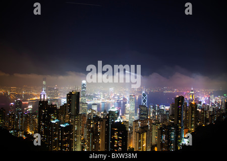 The amazing Hong Kong skyline as seen from above at night. Victoria harbor harbour and Kowloon Stock Photo
