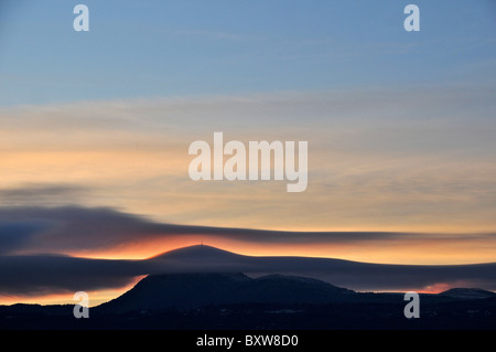 clouds over Puy-de-Dôme volcano at sunse, Park of Auvergne volcanoes, France Stock Photo