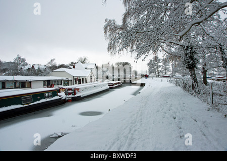 Canal boats in the snow at Farncombe Boathouse on the River Wey in Godalming Surrey Stock Photo