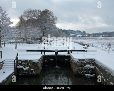 Catteshall Lock in the snow at Farncombe Boathouse on the River Wey in Godalming Surrey Stock Photo