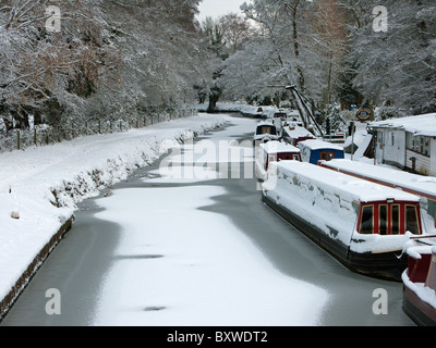 Canal boats in the snow at Farncombe Boathouse on the River Wey in Godalming Surrey Stock Photo