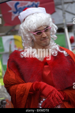 a man in dressed in drag , whilst taken part in the great Christmas pudding race Stock Photo