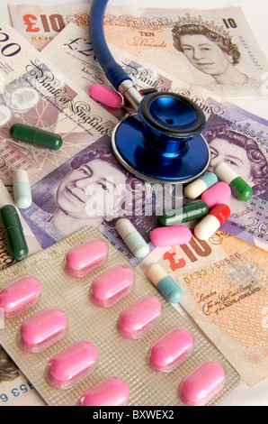 Pound sterling banknotes, stethoscope, pills - NHS health care costs / charges in the UK concept Stock Photo
