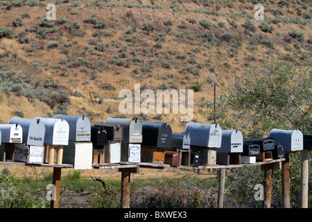 Mailboxes lined up for the delivery of mail in a rural area near Challis, Idaho, USA. Stock Photo