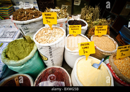 ISTANBUL, Turkey / Türkiye — A vendor's display of herbs, spices, and agricultural products stands near the historic Spice Bazaar (Misir Carsisi). The selection includes traditional Turkish ingredients such as dried herbs, teas, and cooking ingredients with prices listed in Turkish Lira (TL). This shop represents the expansion of the spice trade beyond the bazaar's walls into the surrounding streets of the Eminonu district. Stock Photo