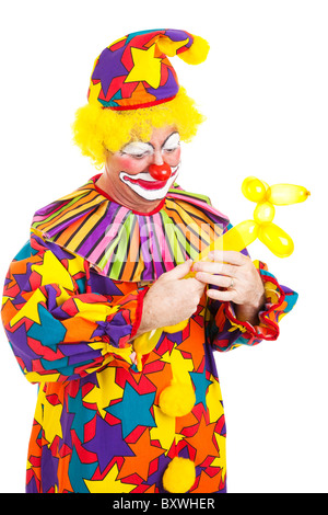 Funny birthday clown twisting a balloon into an animal.  Stock Photo