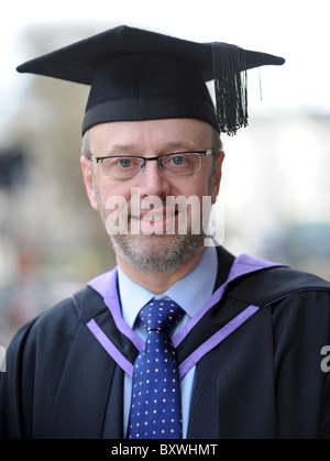 Happy smiling mature male student graduate about to pick up his degree from Sussex University Stock Photo
