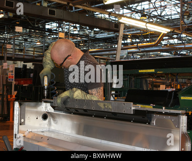 Using a template to drill holes for rivets on a Land Rover Defender rear body Stock Photo