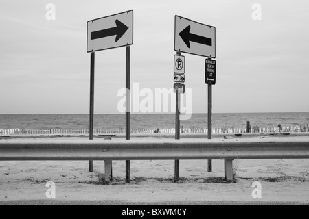 USA, Delaware, Rehobeth Beach, Arrow street signs along Atlantic Ocean on summer morning Stock Photo