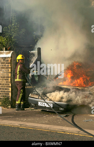 Fire crews tackle a car fire in London Stock Photo