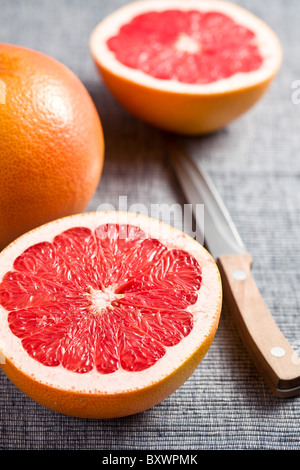 the sliced red grapefruit on kitchen table Stock Photo