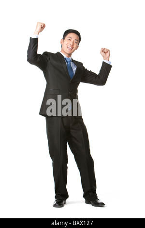 Businessman arms raised in celebration Stock Photo