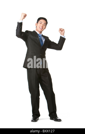 Ecstatic businessman cheering in front of a red background Stock Photo ...