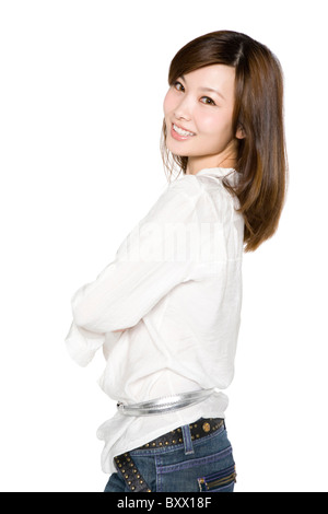 Portrait of Young Woman Looking Over Shoulder with Arms Crossed Stock Photo