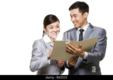 Businessmen looking through papers Stock Photo