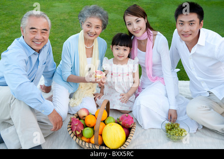 A family gathered around for a picnic Stock Photo