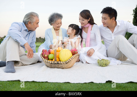 A family gathered around for a picnic Stock Photo